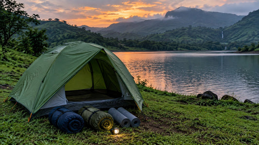 Rented camping tent, sleeping bags and mats pitched by a lake near Pune