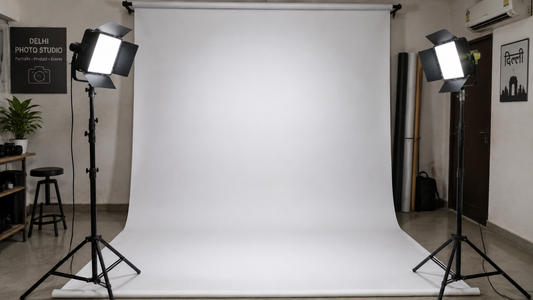 Two LED studio lights on stands lighting a plain backdrop